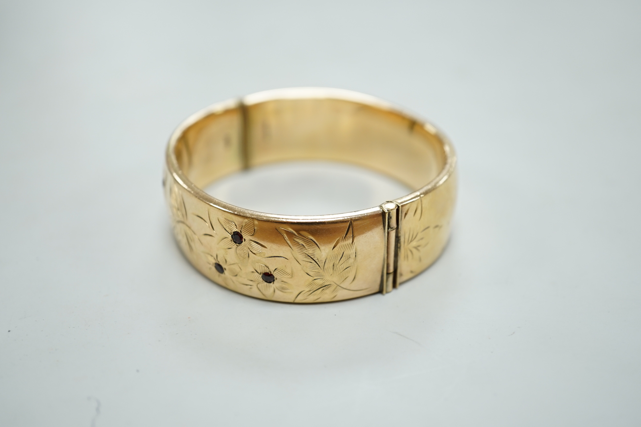 A 1960's 9ct gold hinged bangle, by Smith & Pepper, 30.4 grams and a rolled gold bangle.